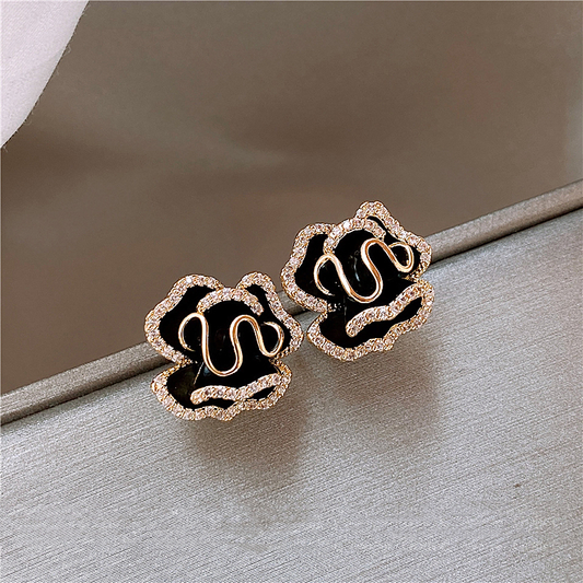 Elegant black lotus earrings with glitter elements